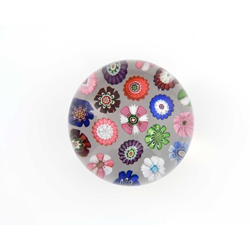 457 - Clichy, a spaced concentric millefiori clear glass paperweight, each cane of a different rosette for... 