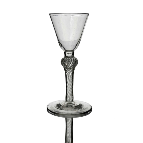 463 - An 18th century single series composite air twist wine glass, circa 1765, the rounded conical bowl o... 