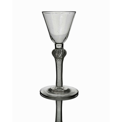 463 - An 18th century single series composite air twist wine glass, circa 1765, the rounded conical bowl o... 