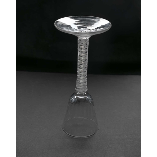 464 - An 18th century opaque twist wine or cordial glass, circa 1770, the half fluted round funnel bowl on... 