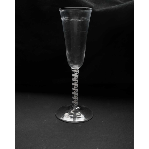 465 - An 18th century opaque twist ale flute, circa 1770, the slender round funnel bowl on a double series... 