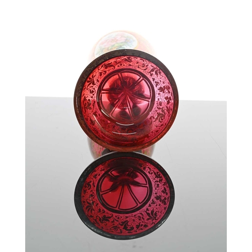 484 - A Bohemian floral plaque red glass goblet vase, 19th century, pedestal chalice form, two opaque oval... 