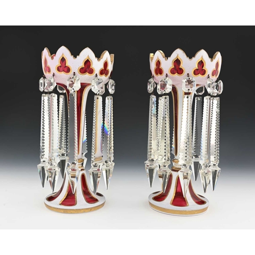 487 - A pair of 19th century Bohemian cased glass lustre candlesticks, white opaque over ruby with gilt bo... 