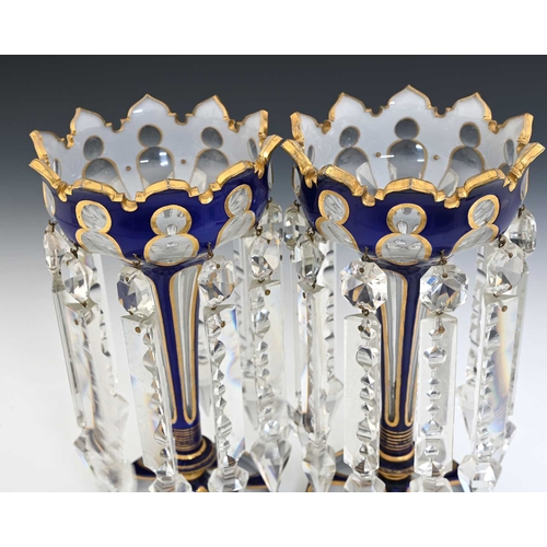 488 - A pair of Bohemian triple cased glass lustre vases, 19th century, ogee trumpet form, blue over white... 