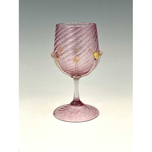 490 - Antonio Salviati, a Venetian Murano glass goblet, pink mottled wrythen moulded with applied aventuri... 