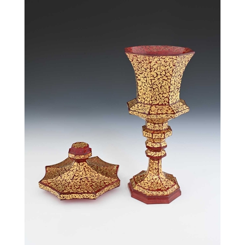 491 - A Bohemian raised gilt and red washed glass chalice and cover, octagonal section slice cut and knopp... 