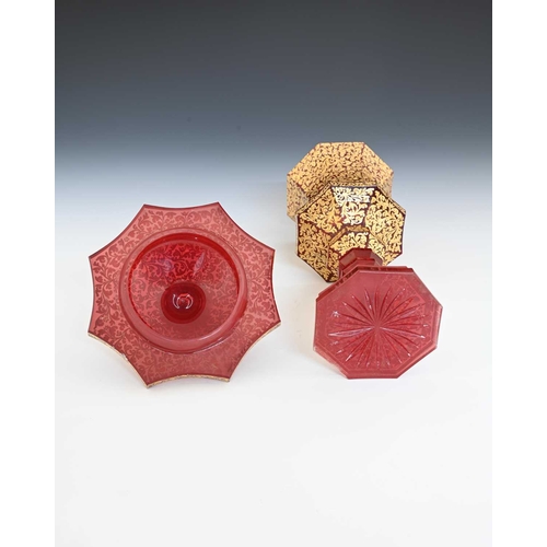 491 - A Bohemian raised gilt and red washed glass chalice and cover, octagonal section slice cut and knopp... 