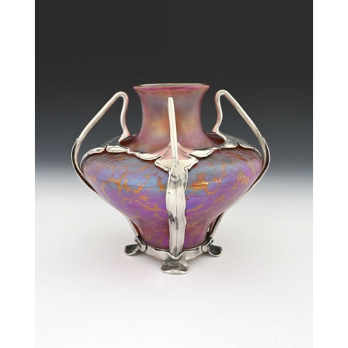 508a - Loetz, a pewter mounted Secessionist iridescent glass vase, twin handled organic cage containing an ... 