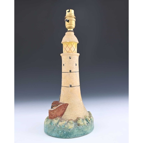 562 - Compton Pottery, a lighthouse lamp base, modelled in relief and painted, 30cm high See: Calvert, H a... 