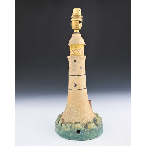 562 - Compton Pottery, a lighthouse lamp base, modelled in relief and painted, 30cm high See: Calvert, H a... 