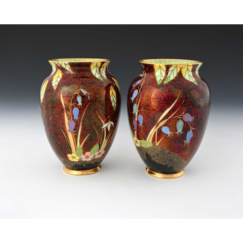 563 - A pair of Carlton Ware Bluebells Rouge Royale vases, shouldered form, decorated with enamelled flowe... 