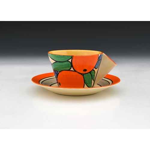 566c - Clarice Cliff, an Oranges tea cup and saucer, conical form