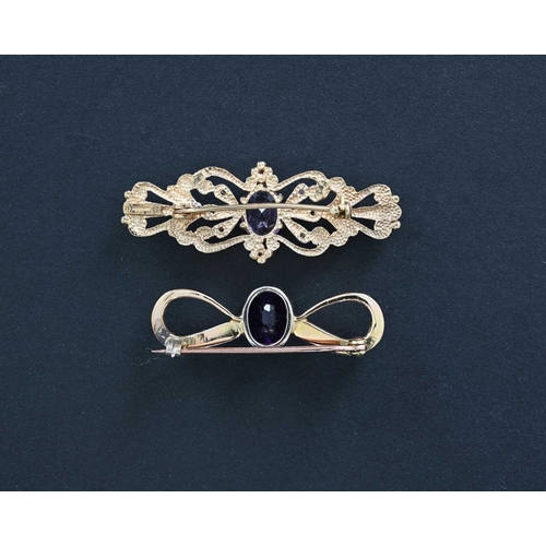 6 - Two gold and amethyst brooches, including a 9 carat foliate bar brooch with diamond chips and centra... 