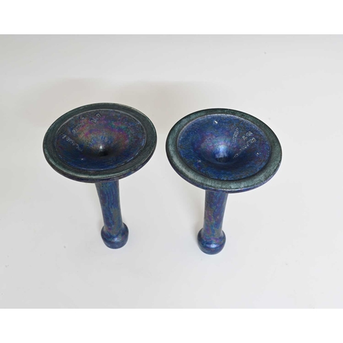 600 - Ruskin Pottery, a pair of Kingfisher blue lustre candlesticks, 1917, tapered trumpet form with poppy... 