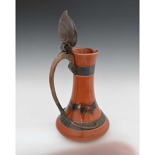 603 - Jesson, Birkett and Co for Ruskin Pottery, a copper mounted claret jug, circa 1905, flared bulbous f... 