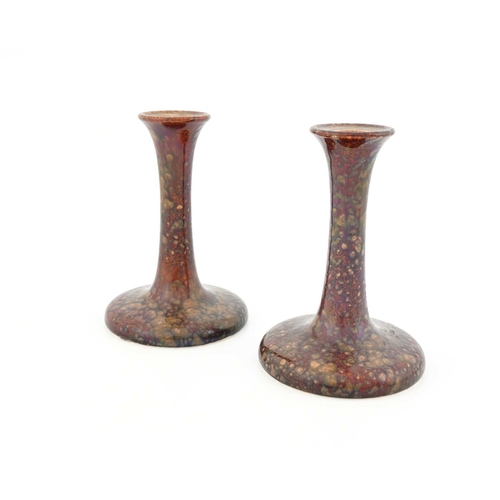 606 - Ruskin Pottery, a pair of candlesticks, 1924, sweeping trumpet form, mottled semi lustre souffle typ... 