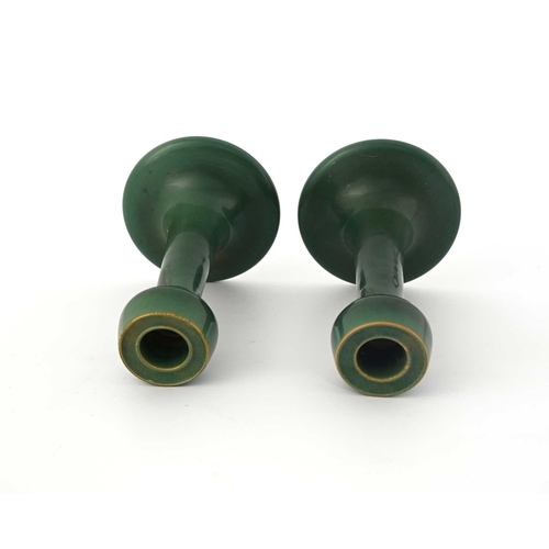 618 - Ruskin Pottery, a pair of Souffle glazed candlesticks, circa 1903, trumpet form with poppy head scon... 