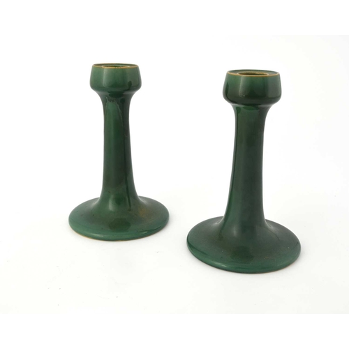 618 - Ruskin Pottery, a pair of Souffle glazed candlesticks, circa 1903, trumpet form with poppy head scon... 