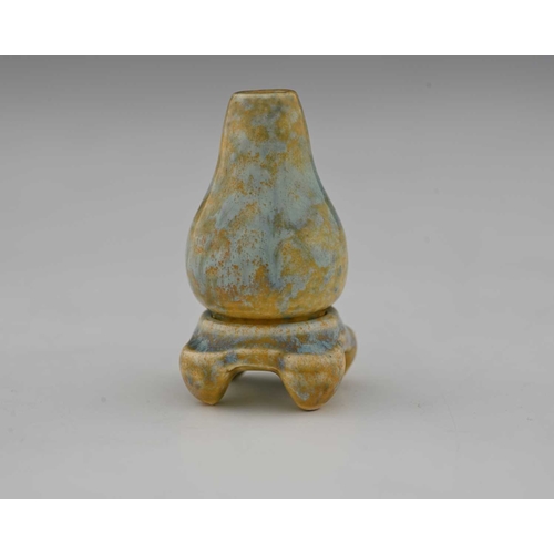 622 - Ruskin Pottery, a miniature glazed vase and stand, circa 1930, gourd bottle form on a foour bracket ... 