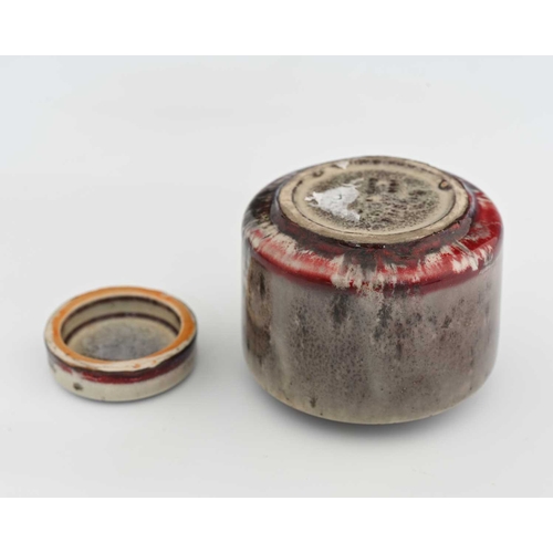 630 - Ruskin Pottery, a High Fired inkwell, 1915, cylindrical drum form with disc lid, the main body with ... 