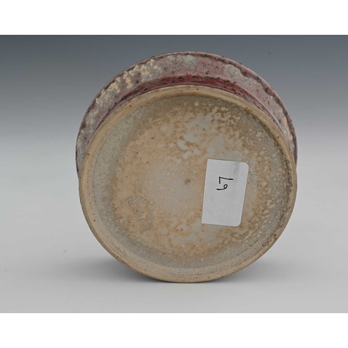 636 - Ruskin Pottery, a High Fired candle holder, 1931, flared circular dish form with central conical sco... 