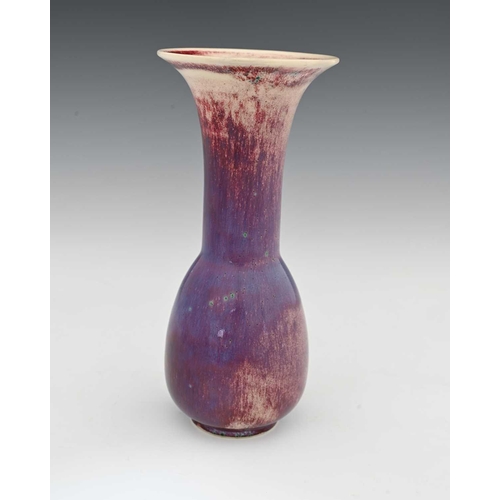 637 - Ruskin Pottery, a High Fired vase, 1925, elongated bulbous bottle form with flared trumpet neck, pur... 