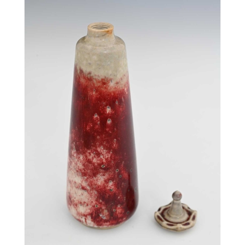 638 - Ruskin Pottery, a High Fired scent bottle and stopper, 1927, conical form with screw top denticulate... 