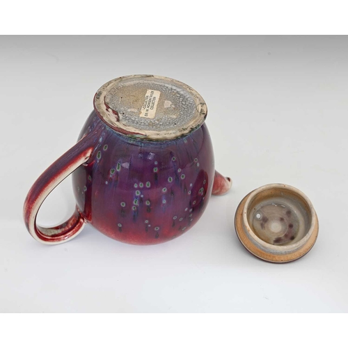 640 - Ruskin Pottery, a High Fired teapot, 1926, footed ovoid form, red sang de boeuf flambe draining to p... 