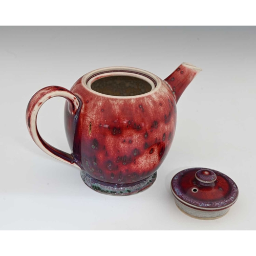 640 - Ruskin Pottery, a High Fired teapot, 1926, footed ovoid form, red sang de boeuf flambe draining to p... 