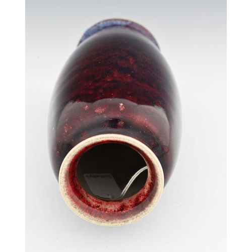 643 - Ruskin Pottery, a High Fired vase, 1910, shouldered barrel form, deep sang de boeuf glaze with blue ... 