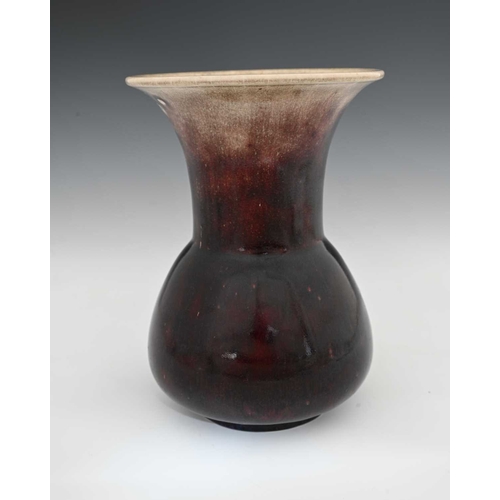 651 - Ruskin Pottery, a High Fired vase, 1912, conical bulbous form with flared trumpet neck, dark sand de... 