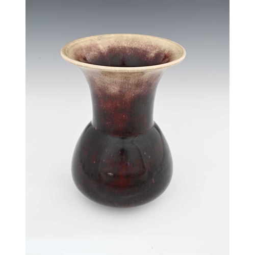 651 - Ruskin Pottery, a High Fired vase, 1912, conical bulbous form with flared trumpet neck, dark sand de... 