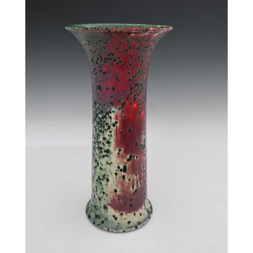 664 - Ruskin Pottery, a High Fired vase, 1905, lily or flared sleeve form, green oxide speckled over sang ... 