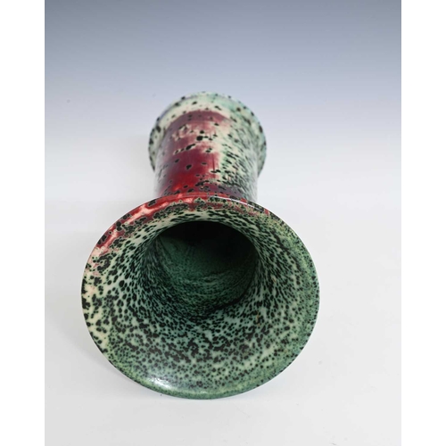 664 - Ruskin Pottery, a High Fired vase, 1905, lily or flared sleeve form, green oxide speckled over sang ... 