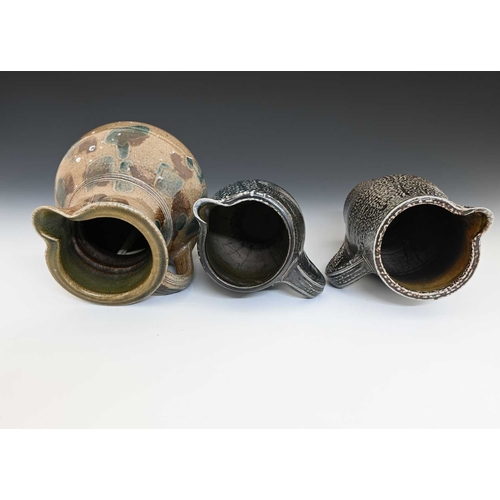 671 - Michael Casson, three studio pottery salt glazed stoneware jugs, obe of slender elongated barrel for... 