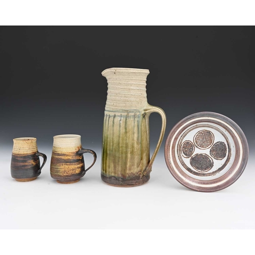 681 - Mary Rich (British, 1940-2022), a stoneware jug, dish, and two mugs, all early pieces with maker's i... 