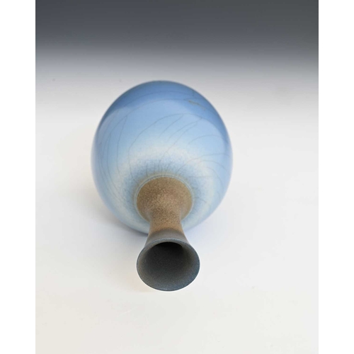 683 - David White (British, 1934-2011), a porcelain narrow-necked bottle vase, decorated with a blue crack... 