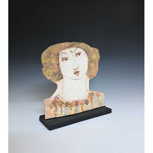 687 - Christy Keeney (British, 1958), a female head in low relief looking right, mounted on a wooden base,... 