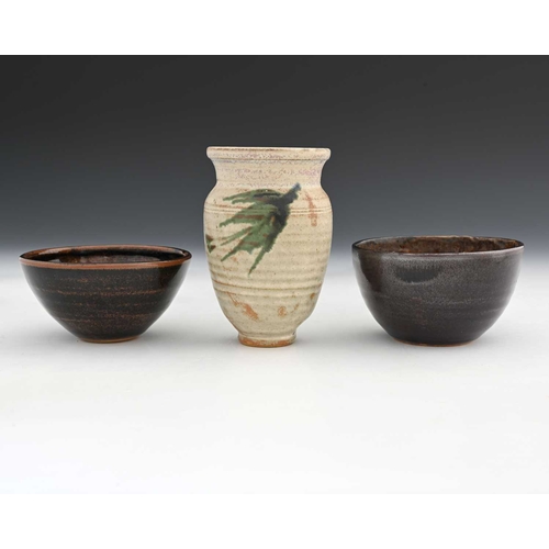 690 - Chris Carter (British, 1945), two tenmoku bowls, maker's mark to the base, and a vase with Draycott ... 