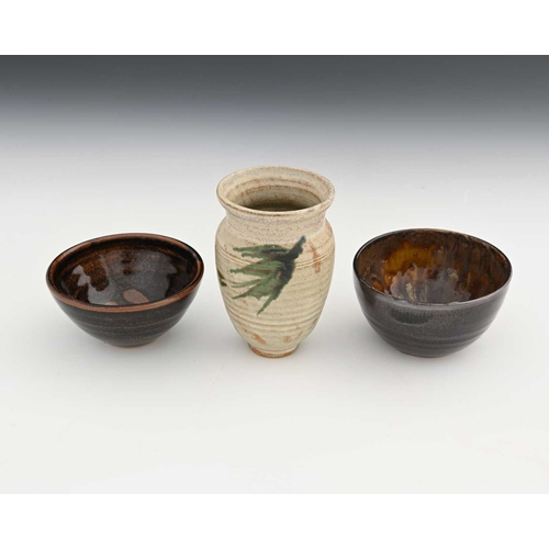 690 - Chris Carter (British, 1945), two tenmoku bowls, maker's mark to the base, and a vase with Draycott ... 