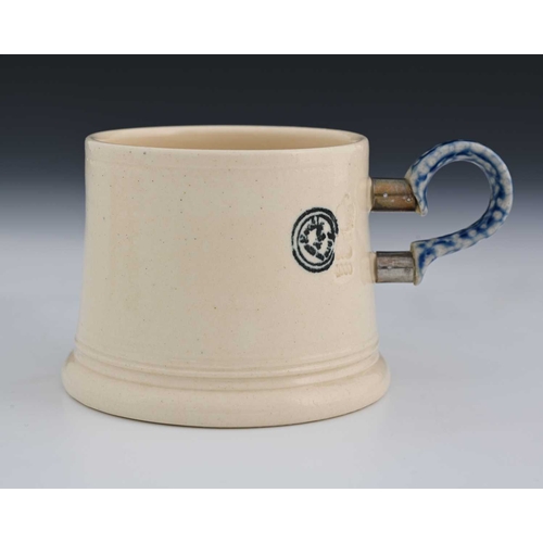 700 - Steve Harrison, a studio pottery mug, 2000, the tapered white glazed body with plate mounted salt ga... 