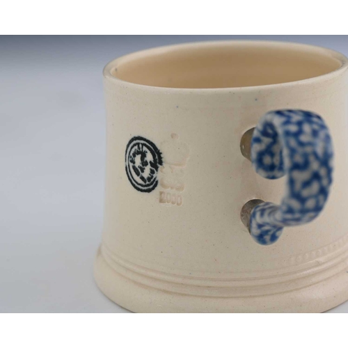 700 - Steve Harrison, a studio pottery mug, 2000, the tapered white glazed body with plate mounted salt ga... 