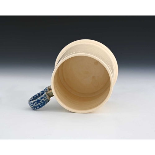 700 - Steve Harrison, a studio pottery mug, 2000, the tapered white glazed body with plate mounted salt ga... 