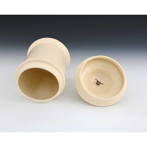 704 - Steve Harrison, a studio pottery jar and cover, 2000, white glazed cylindrical form with dimpled sid... 