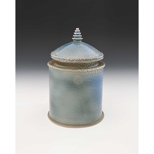 710 - Walter Keeler, a studio pottery salt glazed jar and cover, oval section pale blue glaze, circular co... 