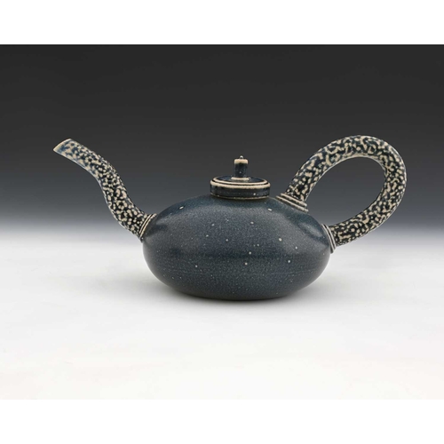 711 - Walter Keeler, a studio pottery salt glazed teapot, squat ovoid body in matte blue with disc lid, ap... 