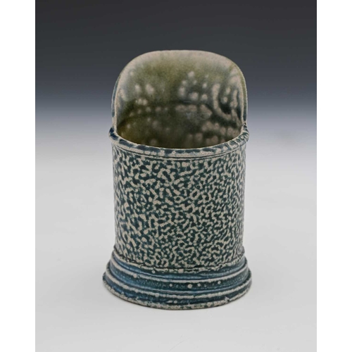 714 - Walter Keeler, a studio pottery salt glazed stoneware jug, lop sided cylindrical form with wide lip,... 