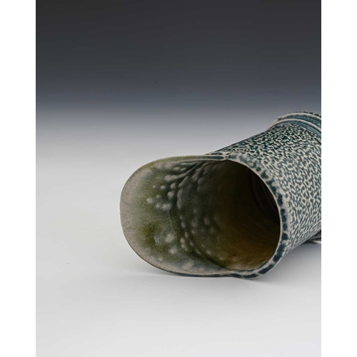 714 - Walter Keeler, a studio pottery salt glazed stoneware jug, lop sided cylindrical form with wide lip,... 