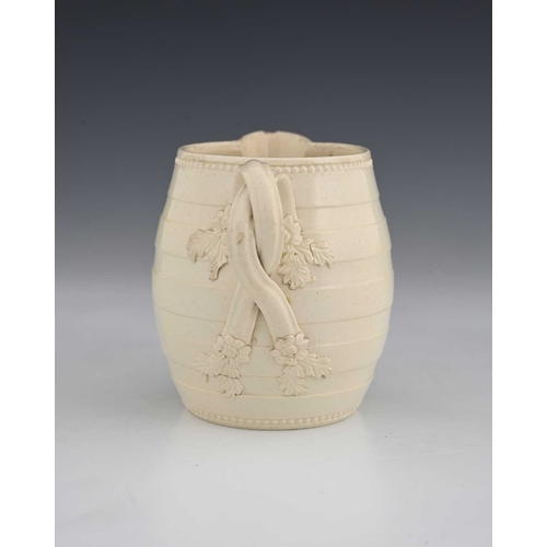 727 - A Leeds creamware mask head milk jug, circa 1780, of barrel form, turned banding with crossover foli... 