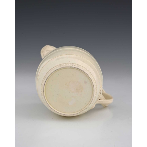 727 - A Leeds creamware mask head milk jug, circa 1780, of barrel form, turned banding with crossover foli... 